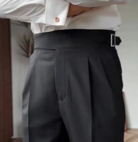 Men's black pleated trousers with a high waist and adjustable tabs