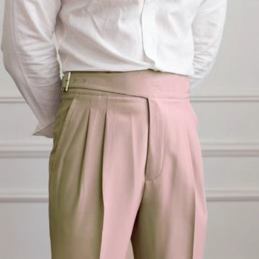 Men's navy blue pleated trousers with a high waist and adjustable tabs