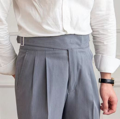 Men's navy blue pleated trousers with a high waist and adjustable tabs