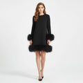 Women's black mini dress with a faux fur hem and long sleeves