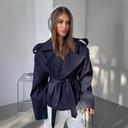 Oversized short trench coat with tie belt, product still life