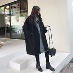 Women's black oversized wool blend trench coat with a tailored fit