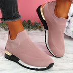 Women's slip on trainers with a gold heel detail and a wide fit, on foot view