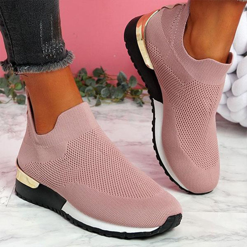 Women's slip on trainers with a gold heel detail and a wide fit, on foot view