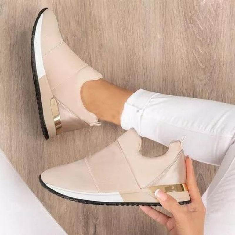 Women's beige slip on trainers with a gold heel detail and a wide fit