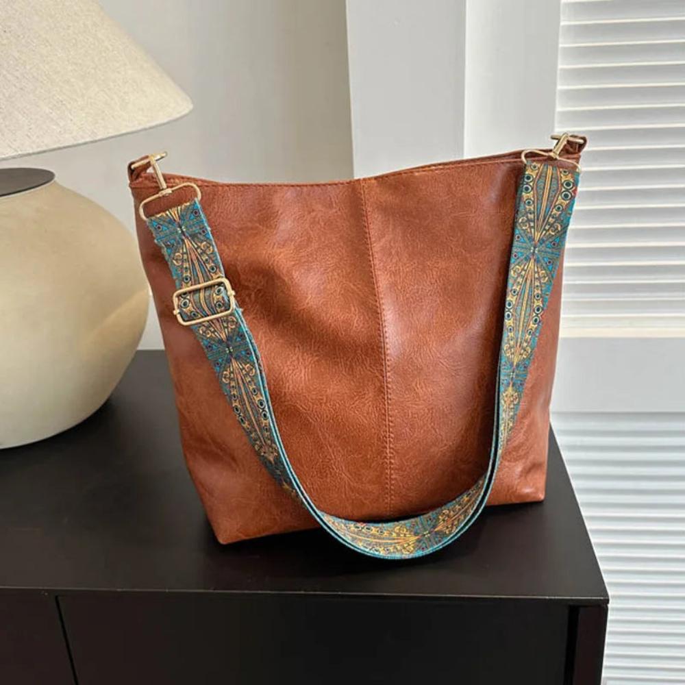 Tote bag with decorative strap detail, product still life