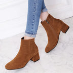 Suede ankle boots with block heel and side zip, product still life