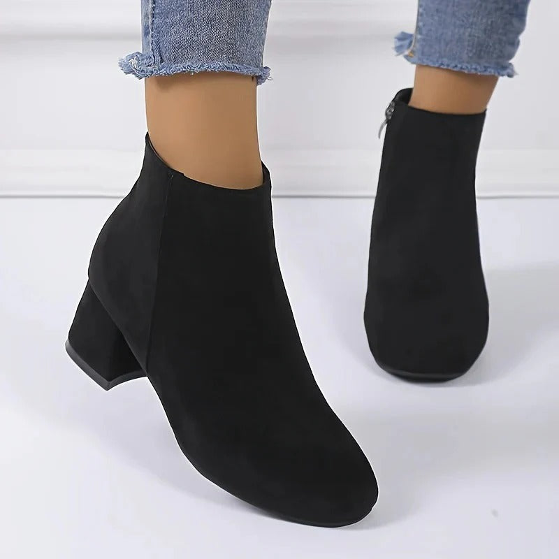 Suede ankle boots with block heel and side zip, product still life