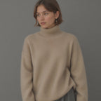 Beige oversized cashmere roll neck jumper with an oversized, cosy drape