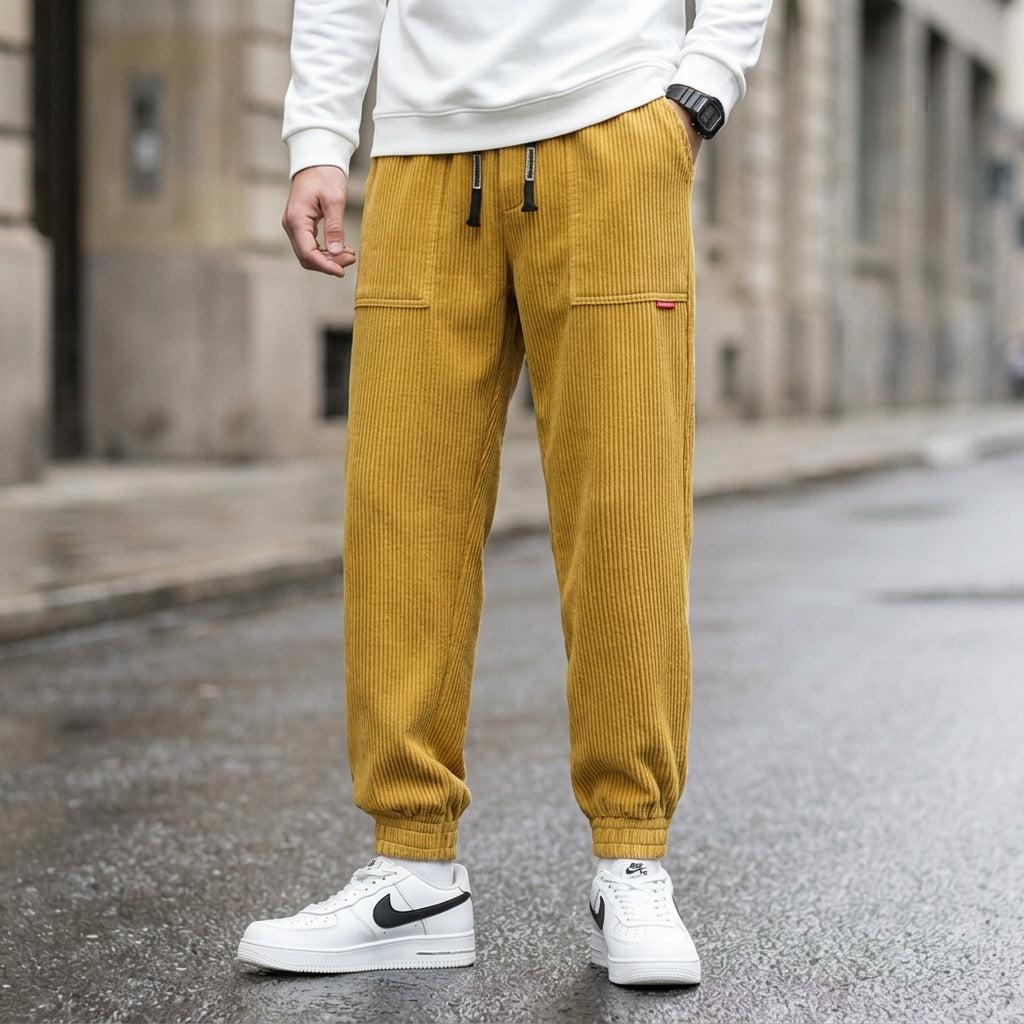 Men's mustard yellow corduroy joggers with a tapered fit and cuffed hem