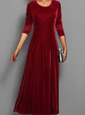 Women's burgundy velvet long sleeve maxi dress with an A line skirt