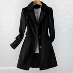 Vintage-style coat with trench collar and button front, product still life
