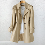 Vintage-style coat with trench collar and button front, product still life