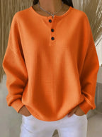 Women's orange oversized waffle knit henley sweatshirt