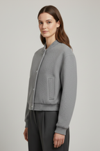 Cropped jacket with snap fastening and ribbed cuffs, product still life