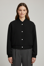 Cropped jacket with snap fastening and ribbed cuffs, product still life
