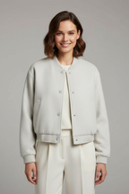 Cropped jacket with snap fastening and ribbed cuffs, product still life