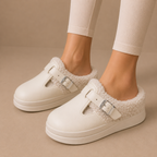 Fleece-lined slippers with cushioned footbed and buckle strap, product still life