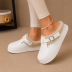 Fleece-lined slippers with cushioned footbed and buckle strap, product still life