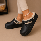 Fleece-lined slippers with cushioned footbed and buckle strap, product still life