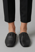 Black leather mules with cap toe and slip-on fit