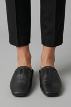 Black leather mules with cap toe and slip-on fit