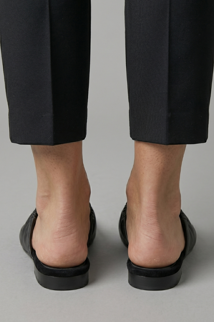 Black leather mules with cap toe and slip-on fit