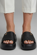 Leather open-toe mule slippers with platform sole, product still life