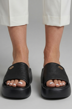 Leather open-toe mule slippers with platform sole, product still life