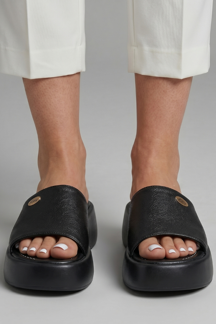 Leather open-toe mule slippers with platform sole, product still life
