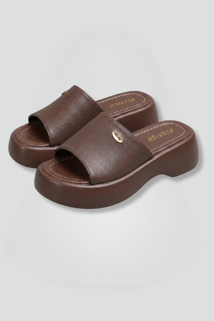 Leather open-toe mule slippers with platform sole, product still life