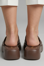 Leather open-toe mule slippers with platform sole, product still life