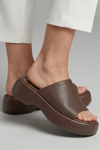 Leather open-toe mule slippers with platform sole, product still life
