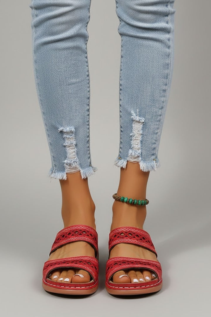 Dual-strap slide sandals with decorative cutouts, product still life