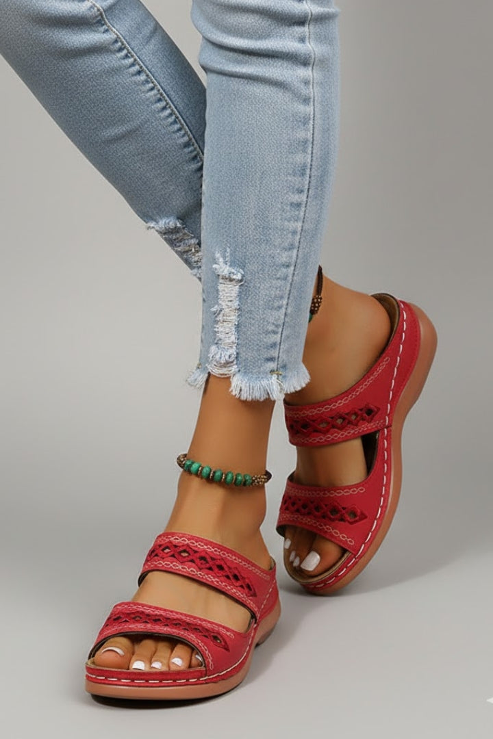 Dual-strap slide sandals with decorative cutouts, product still life