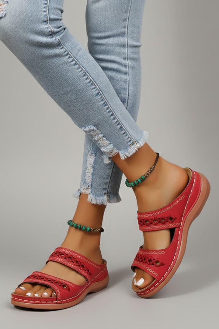 Dual-strap slide sandals with decorative cutouts, product still life