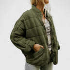 Women's green quilted jacket with a soft lining and relaxed fit
